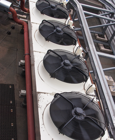 HVAC system rooftop unit featuring multiple black fans and ductwork, emphasizing the importance of proper ventilation and airflow for efficient heating and cooling.