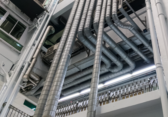 Ductwork and ventilation pipes in a commercial setting, illustrating HVAC system design and airflow management for efficient indoor climate control.