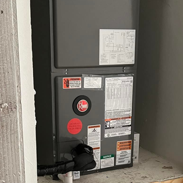 Rheem heating system installed in a utility space, featuring operational labels and safety notices, emphasizing HVAC services for comfort and efficiency in the Rio Grande Valley.