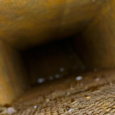 Duct interior showing dust and debris buildup, emphasizing the need for professional duct cleaning services in HVAC maintenance.