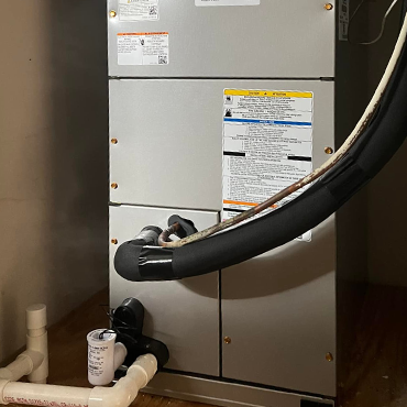 HVAC system unit in maintenance, featuring visible labels and piping, representing L&S Air LLC's heating and cooling services in the Rio Grande Valley.