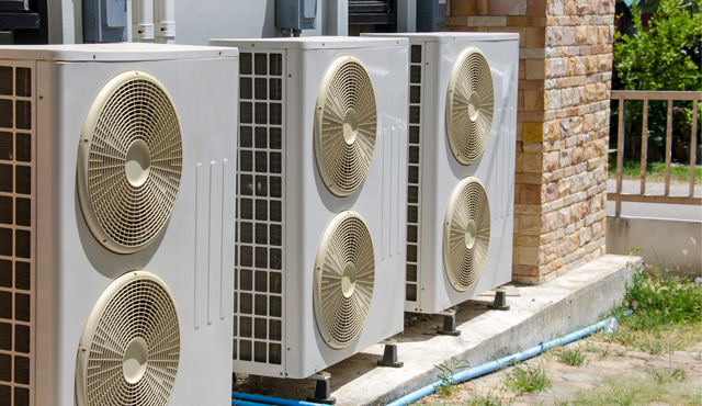 Air conditioning units installed outside a building, showcasing multiple systems designed for efficient cooling in the Rio Grande Valley climate.