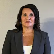 Shana Lively, co-owner and finance manager of L&S Air LLC, standing confidently in a professional gray blazer, emphasizing her role in the trusted HVAC service provider in San Juan.